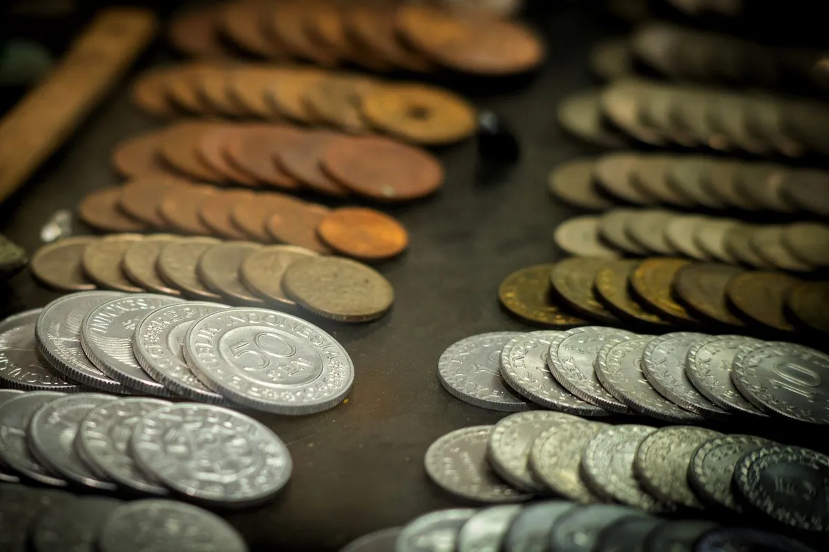 Close-up of vintage Indonesian coins showcasing different denominations and materials relevant to coin selling.