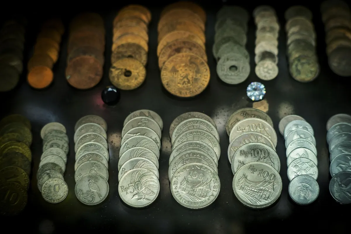 A collection of antique Indonesian coins, highlighting historical currency relevant to global market trends.