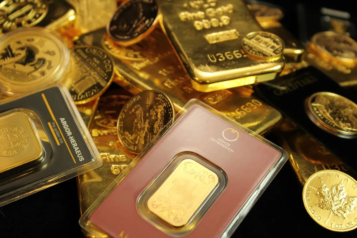 Close-up of gold bars and coins representing wealth and investment, relevant to coin appraisal errors.