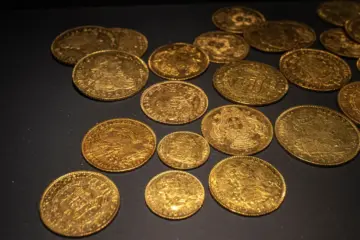 Old gold coins displayed on a black background, highlighting the importance of accurate appraisal.